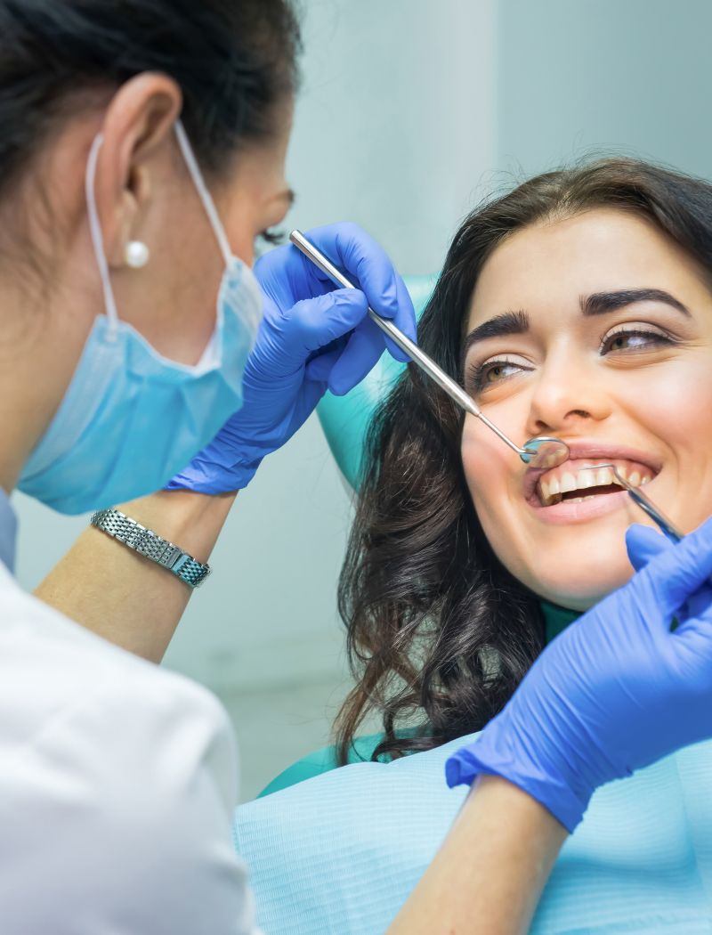 Dental assistant working chairside with a patient