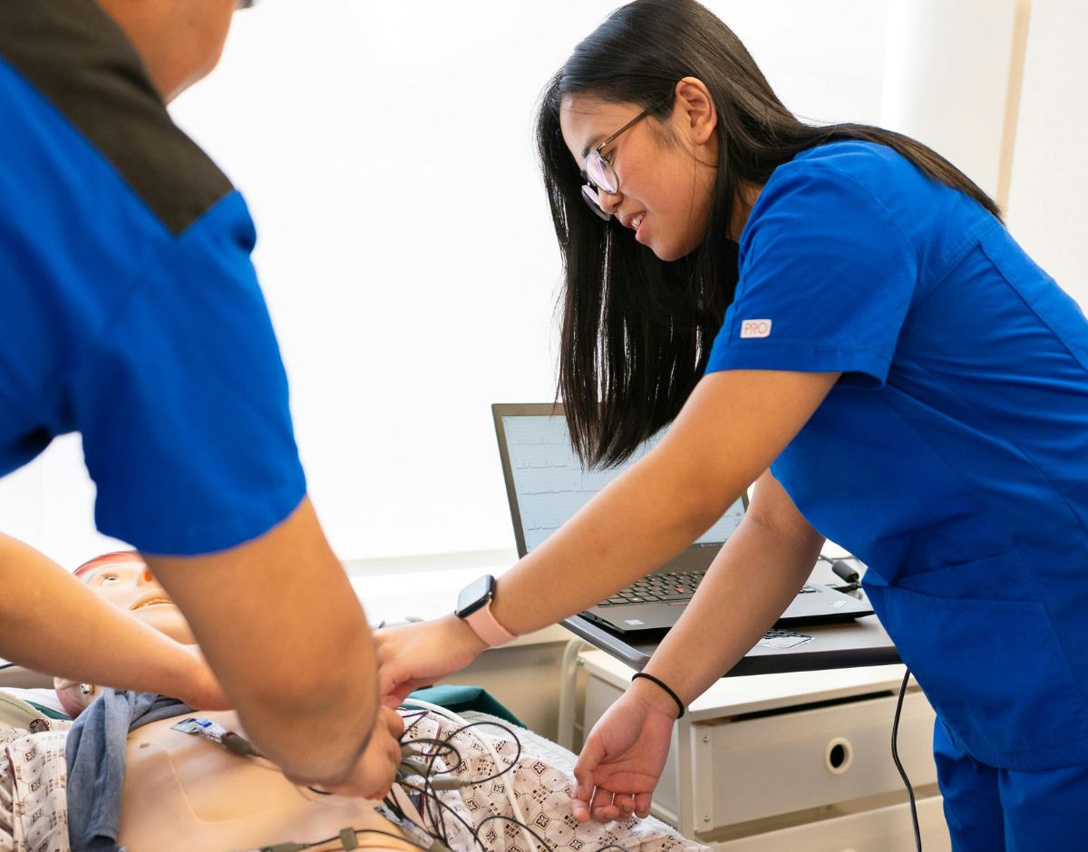 EKG Technician student placing electrodes on a patient